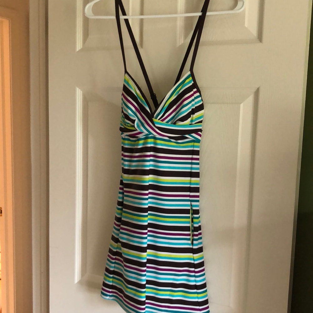 One piece bathing suit, dress style with attached bottoms, pockets on each side